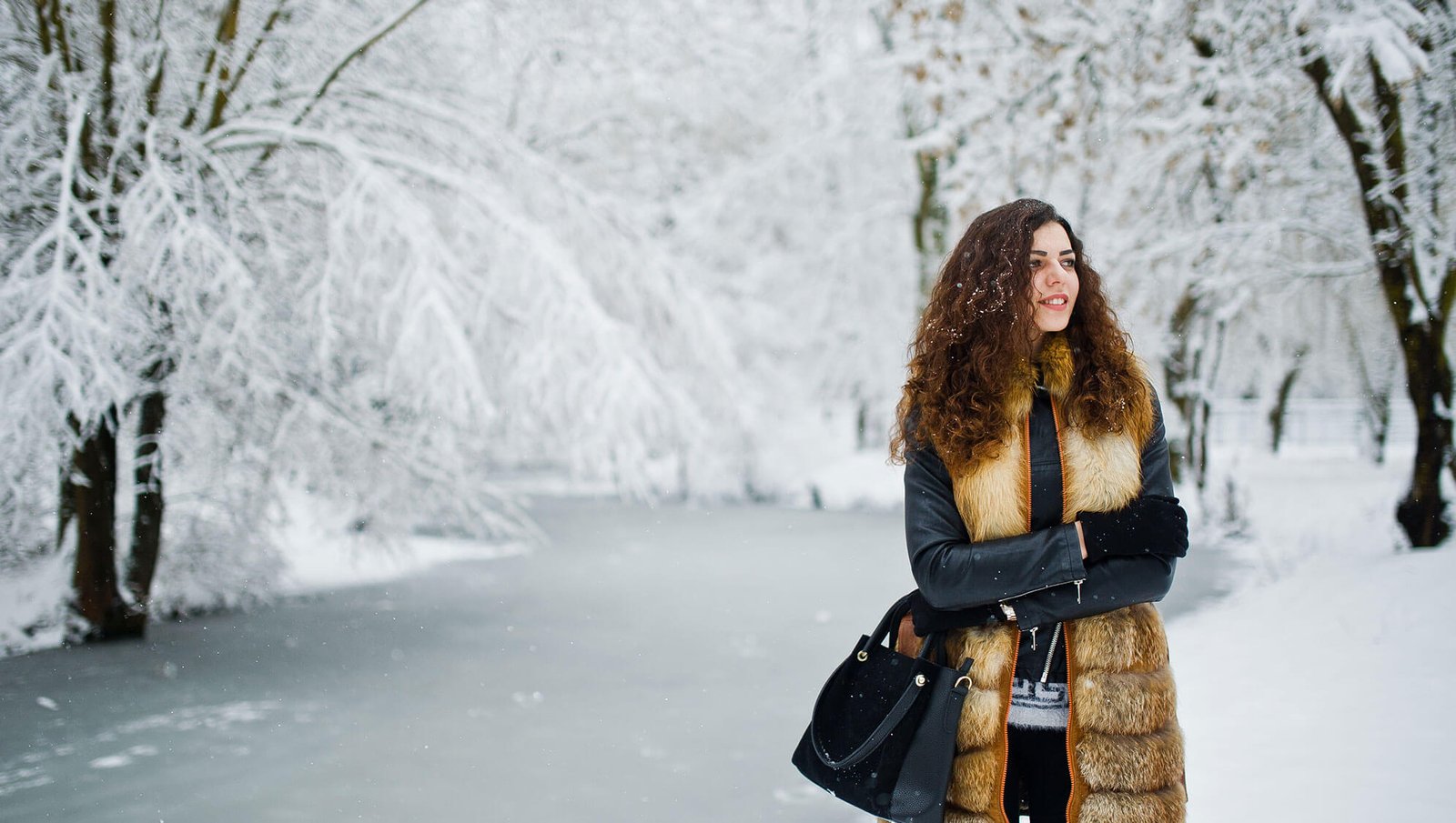 the blond hair girl is standing in snow place and enjoy the snowy weather