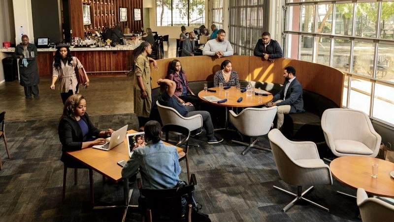 Entrepreneurs networking and collaborating in an Atlanta co-working space, showcasing the city's thriving startup culture and available resources.