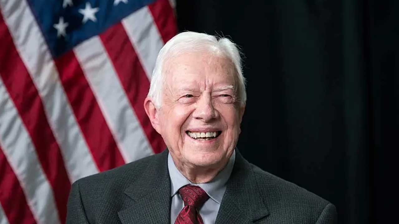 jimmy carter smiling warmly an American flag in the background and symbolizing patriotism and leadership.