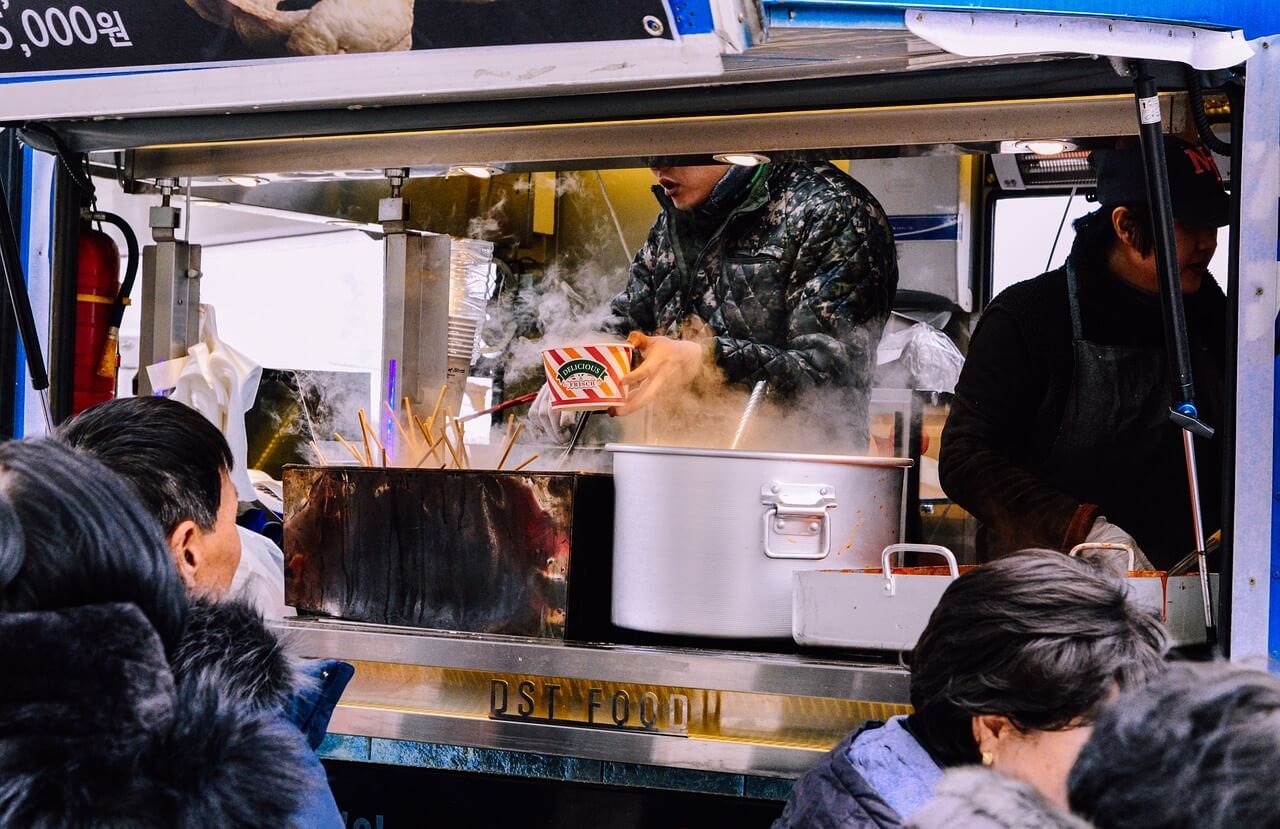 Food truck serving customers at a lively outdoor event in the city, showcasing the vibrant mobile culinary scene of Local 9.